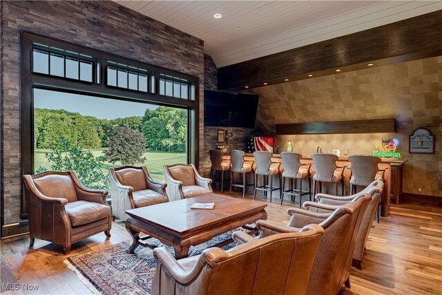 home theater room featuring wood ceiling, high vaulted ceiling, and light wood-type flooring