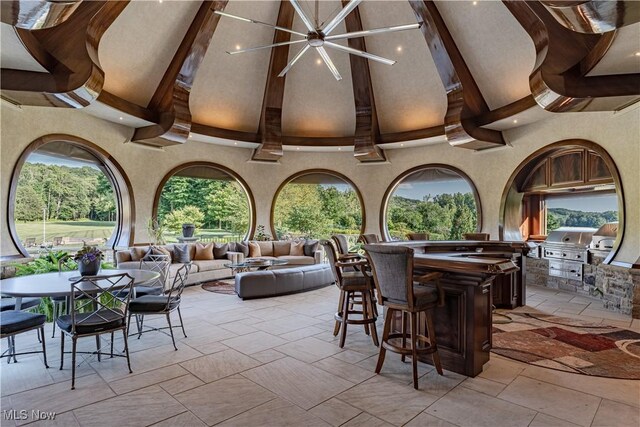 view of patio / terrace featuring a bar, area for grilling, an outdoor kitchen, outdoor lounge area, and ceiling fan