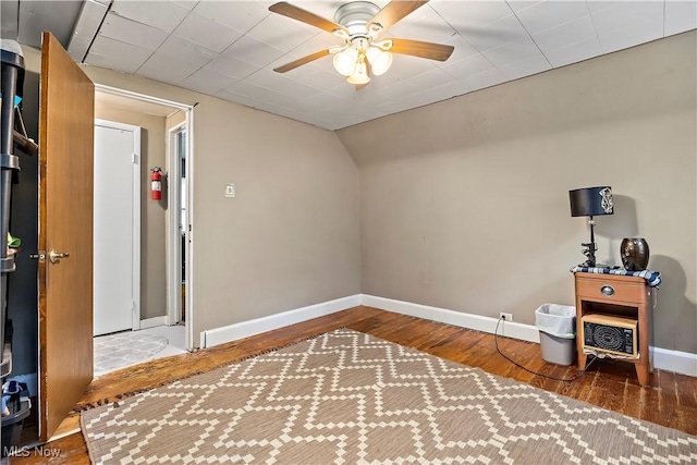 interior space with ceiling fan and dark hardwood / wood-style floors