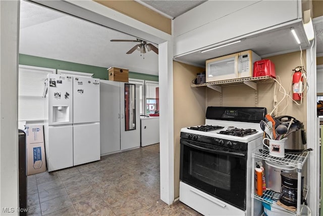 kitchen with ceiling fan, washer / dryer, and white appliances