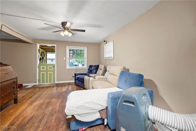 living room featuring wood-type flooring and ceiling fan