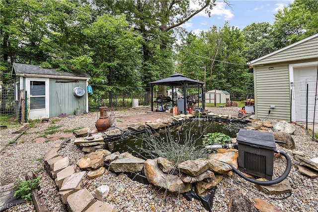 view of yard featuring a gazebo and a storage unit