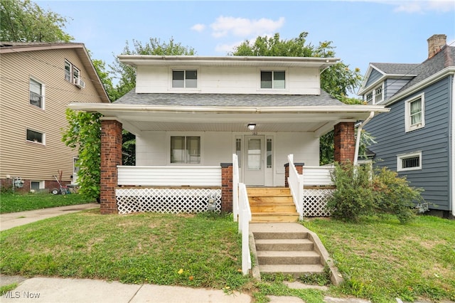 view of front of property featuring a front lawn and covered porch