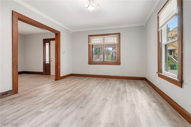 unfurnished room featuring light hardwood / wood-style floors and crown molding