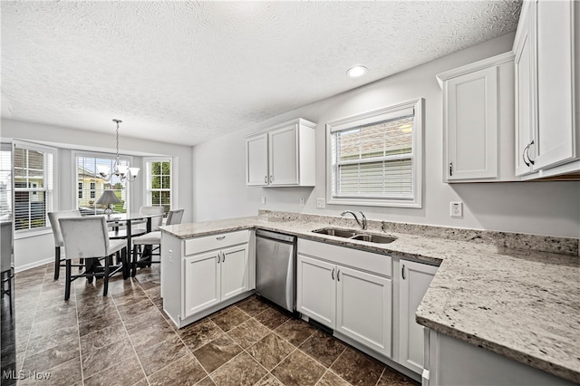 kitchen featuring dishwasher, pendant lighting, white cabinetry, and sink