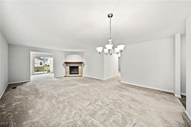 unfurnished living room with carpet flooring, a textured ceiling, and a chandelier