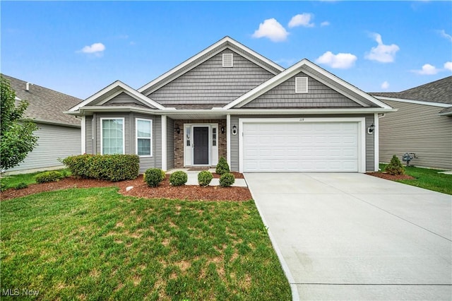 view of front facade with a front yard and a garage