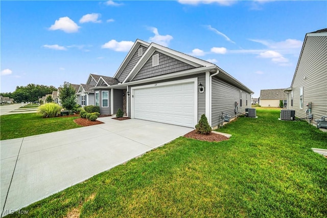 view of front of house with a front yard, central AC, and a garage