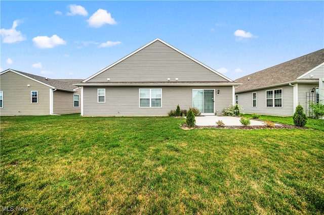 rear view of property with a patio and a lawn