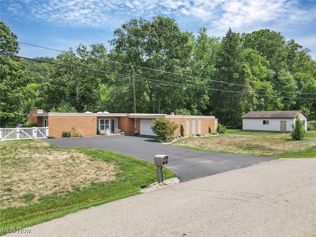 view of front of house with a front yard and a garage