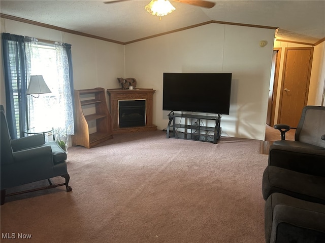 carpeted living room featuring a textured ceiling, vaulted ceiling, crown molding, and ceiling fan