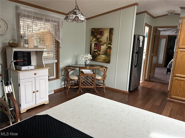 dining area featuring ceiling fan, a textured ceiling, dark hardwood / wood-style flooring, and lofted ceiling