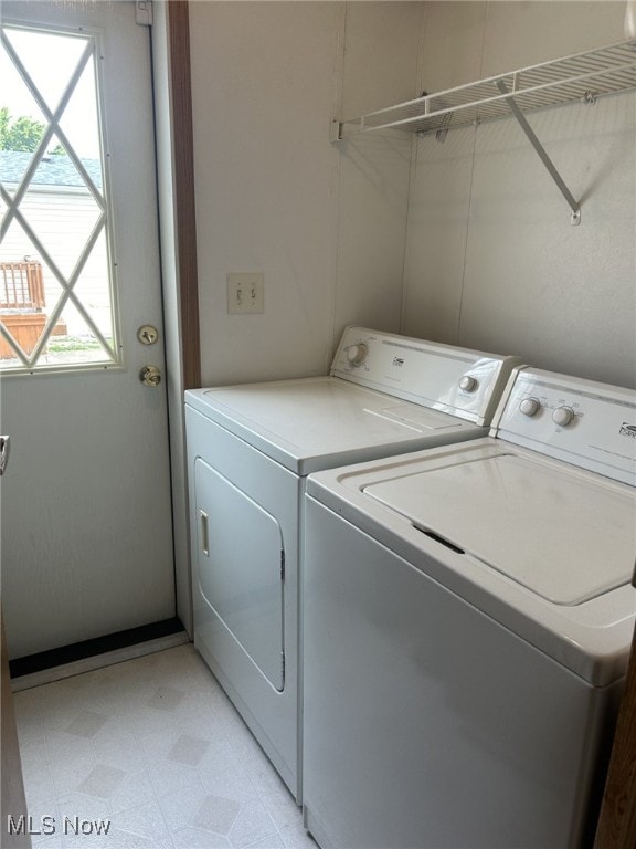 washroom with light tile patterned flooring and separate washer and dryer