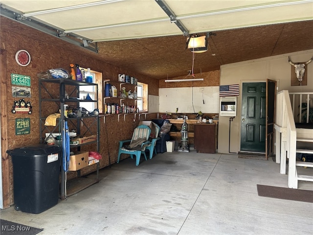 garage featuring a garage door opener and a workshop area