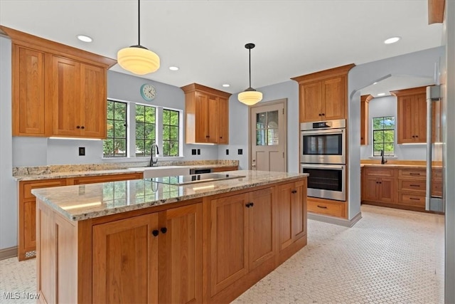 kitchen with double oven, black electric stovetop, a wealth of natural light, and recessed lighting