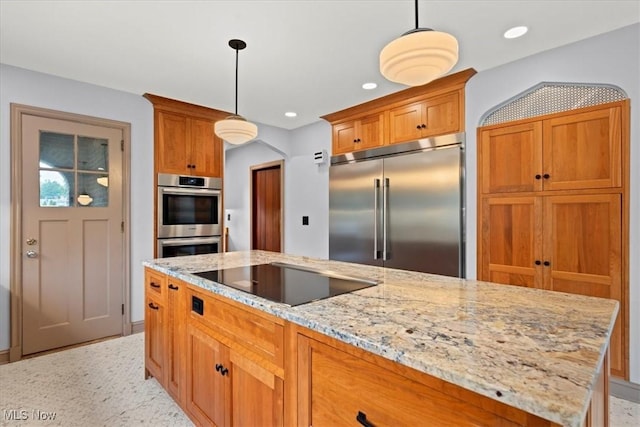 kitchen with light stone counters, recessed lighting, hanging light fixtures, appliances with stainless steel finishes, and brown cabinets