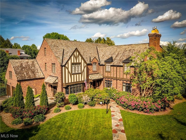 rear view of house with a yard