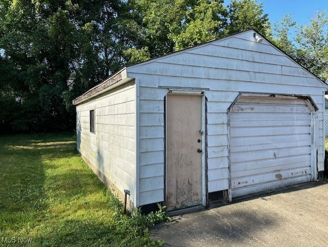 view of outbuilding with a yard