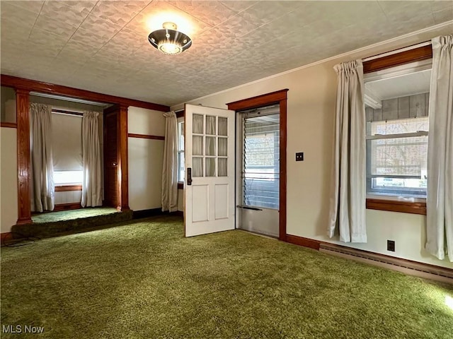 interior space featuring ornamental molding, baseboard heating, and baseboards