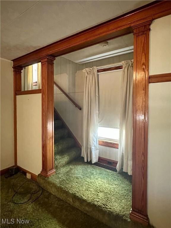 basement featuring stairs and carpet floors