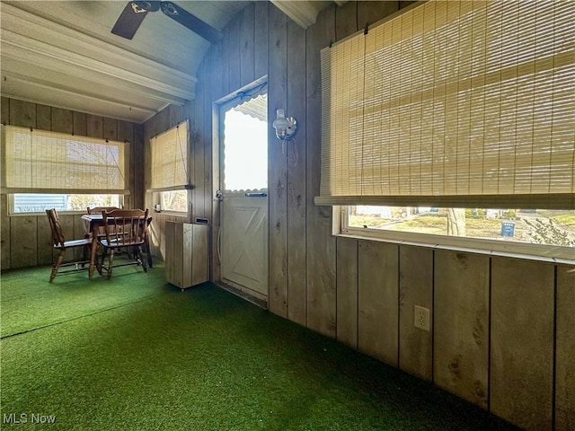 unfurnished sunroom featuring a healthy amount of sunlight, ceiling fan, and lofted ceiling