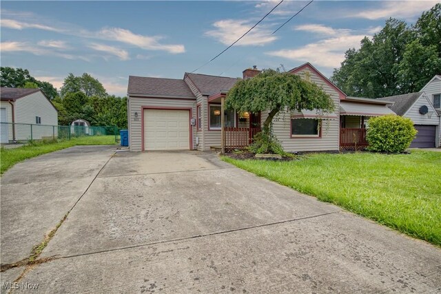 ranch-style house with a garage and a front lawn