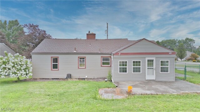 back of house with a patio and a yard