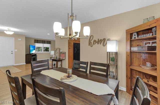 dining area featuring a notable chandelier and light hardwood / wood-style flooring