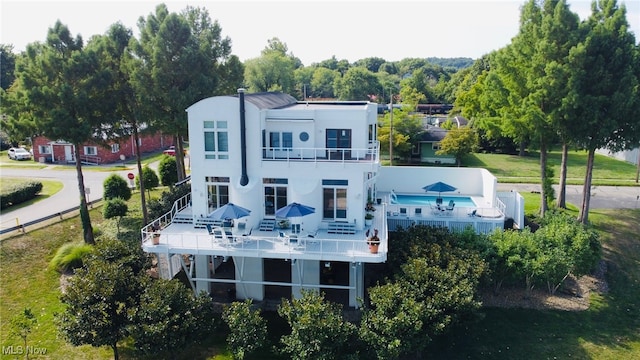 rear view of property with a balcony