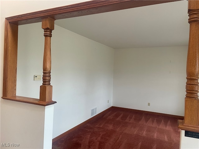 unfurnished living room featuring dark colored carpet