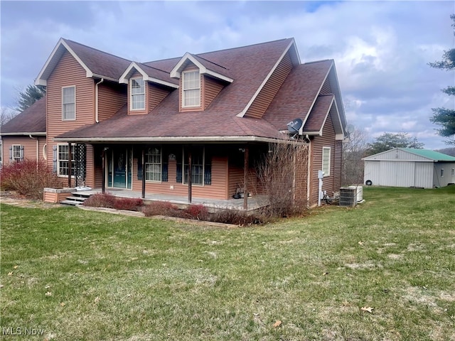 view of front of property with a front yard, covered porch, and central air condition unit