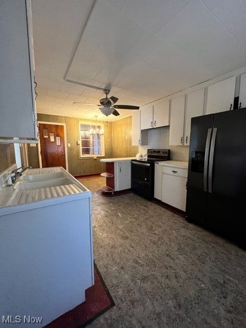 kitchen with ceiling fan, white cabinets, range with electric cooktop, black fridge, and sink