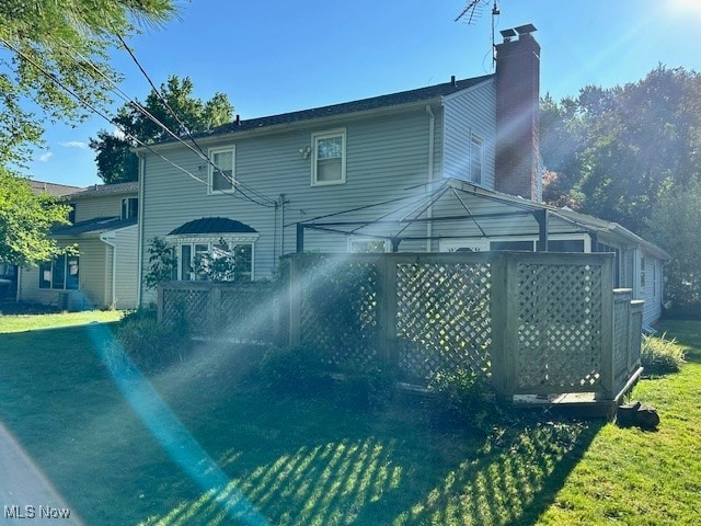 back of property featuring a gazebo and a yard