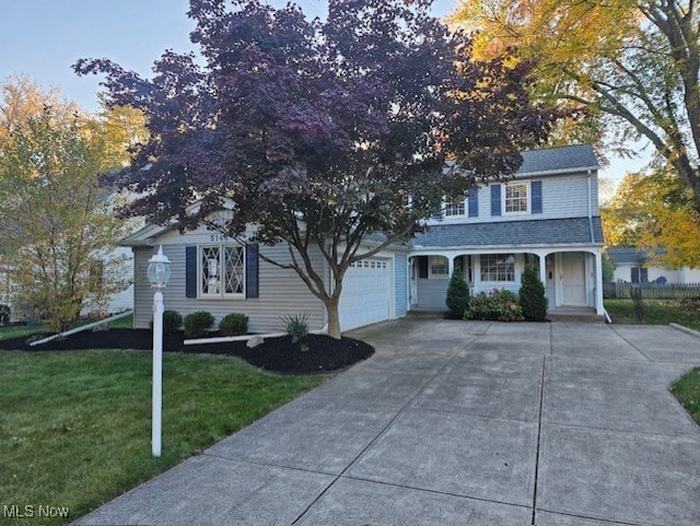 view of front of property with a front yard and a garage