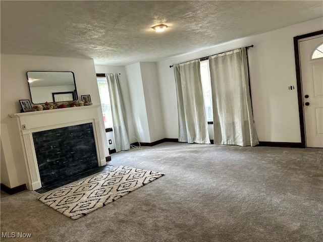 unfurnished living room with a textured ceiling and light carpet