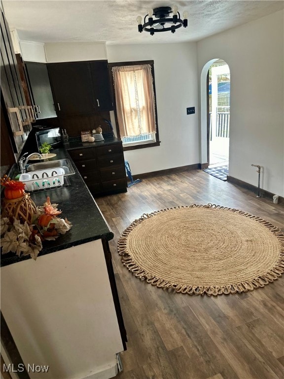 interior space featuring dark wood-type flooring, a textured ceiling, and sink