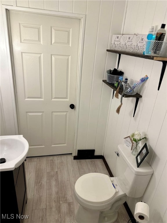 bathroom featuring hardwood / wood-style flooring, vanity, and toilet