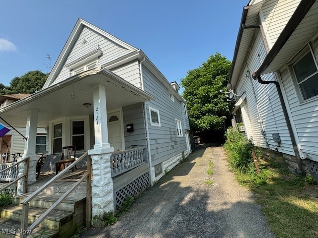 view of side of property with a porch