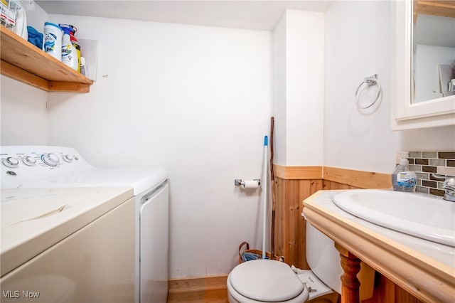 interior space with vanity, decorative backsplash, toilet, and washer and dryer