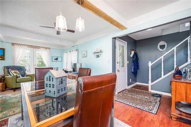 dining room with ceiling fan, french doors, beamed ceiling, and hardwood / wood-style floors