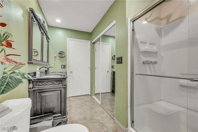 bathroom featuring walk in shower, vanity, toilet, and tile patterned floors