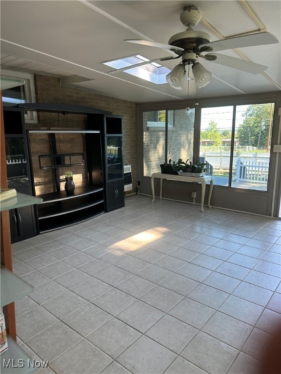 unfurnished sunroom featuring ceiling fan