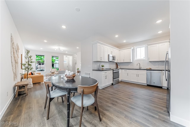 dining room featuring hardwood / wood-style flooring and sink