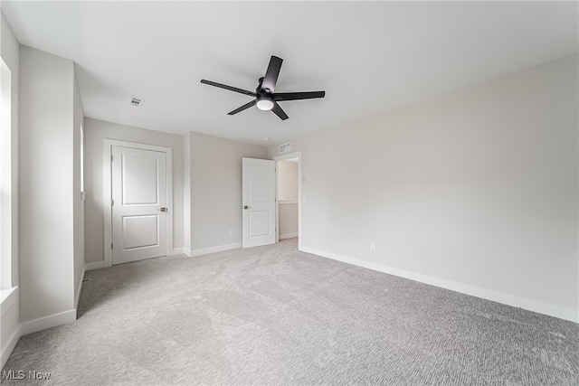 unfurnished bedroom featuring ceiling fan and light carpet