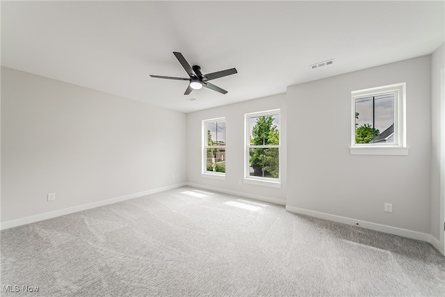 empty room with ceiling fan and carpet floors