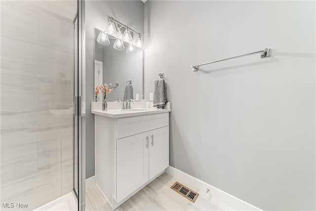 bathroom with vanity and a shower with door