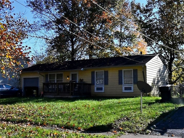 single story home featuring a garage and a front lawn