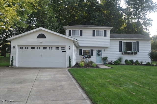 view of front of house with a front yard and a garage