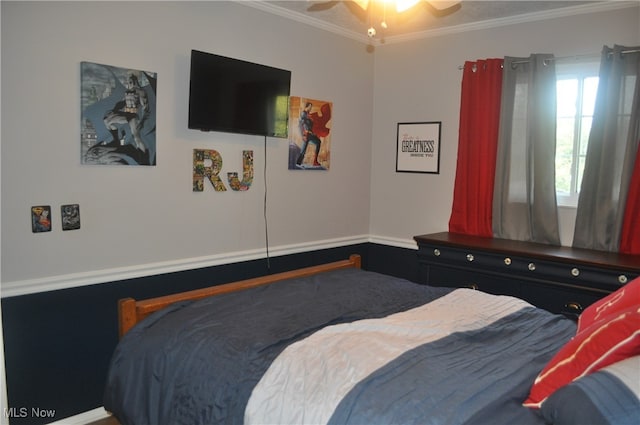 bedroom with ceiling fan and crown molding