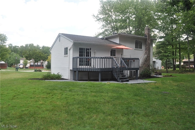 back of house with a yard and a deck